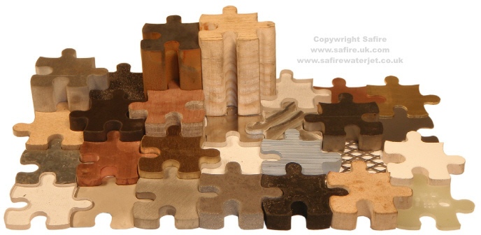 A large sample selection of waterjet cut parts in a variety of materials