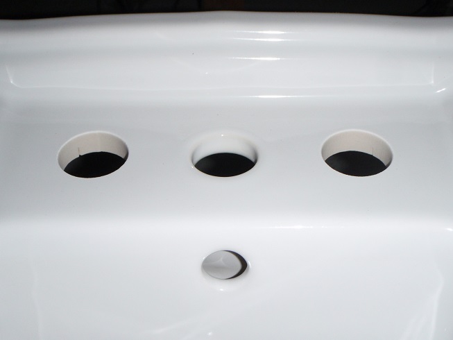 close up of water jet cut drilled holes in bidet